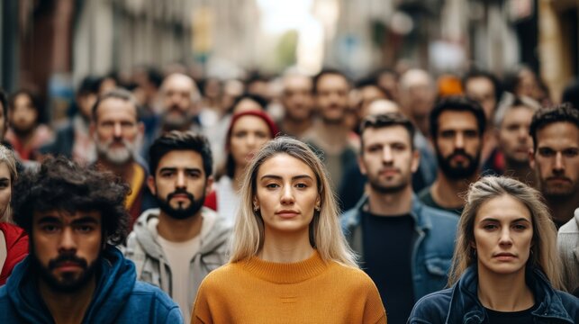 A crowded urban street scene featuring diverse faces that represent various age groups and ethnicities, symbolizing demographic diversity and multiculturalism. 