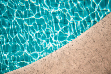 swimming pool with rippled water in sunny day in the summer