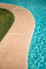 swimming pool with rippled water in sunny day in the summer