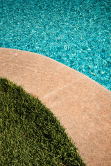 swimming pool with rippled water in sunny day in the summer