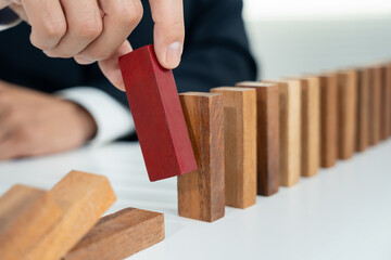 insurance with hands protect domino. Businessman hands stop dominoes falling in business crisis. business risk control and planning and strategies to run prevent insurance businesses.