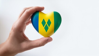 手で持っているセントビンセントおよびグレナディーン諸島の国旗のハート(Heart of Saint Vincent and the Grenadines flag held in hand.)
