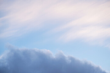 Soft pastel sky with scattered clouds in the morning light.