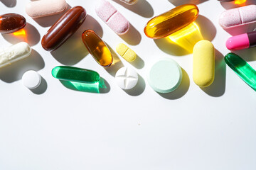 A lot of colorful medication pills capsules tablets softgel supplements, fish oil, vitamin, omega 3