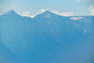 Distant mountain peaks shrouded in mist