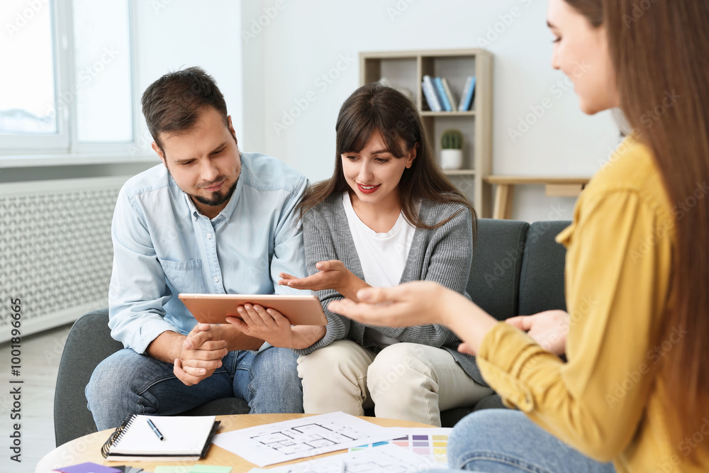 Poster designer discussing project with clients at table in office