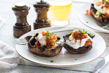 Portobello mushroom eggs Benedict topped with salsa and thyme sprigs.