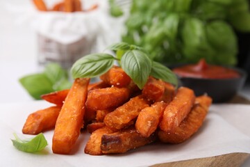 Sweet potato fries and basil on table, closeup