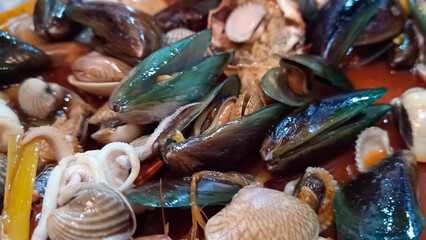 Close up of various seafood dishes with crab and shells