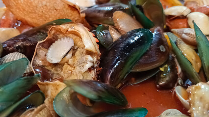 Close up of various seafood dishes with crab and shells