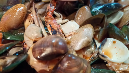Close up of various seafood dishes with crab and shells