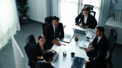 Top view of skilled project manager shake hand and invite business man to talking about marketing plan. Smart investor standing at whiteboard and analysis financial graph at meeting room. Directorate.
