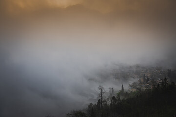 Orange sunrise sky at the rice terraces, dense fog and Duoyishu village, China