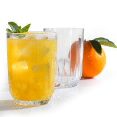 glass of ice with orange juice and mint isolated on white