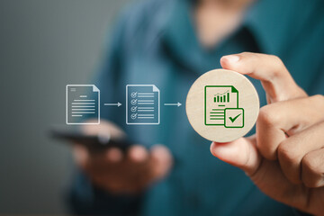 Businessman holding wooden block with document approval icon to paperless online approval for business process workflow illustrating management approval and project approve concept.