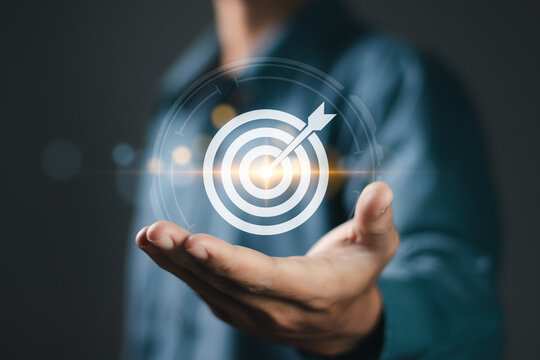Business achievement objective target concept, strategic planning for business growth and target customer group. Businessman holding target icon for business objective.