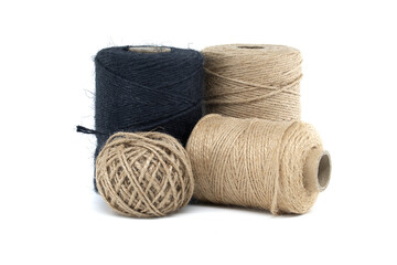 Collection of jute and twine spools on a white background, highlighting natural fiber materials