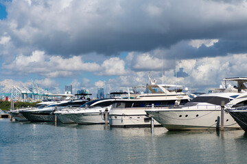 Fototapeta premium Marina in Miami Beach, Florida USA. Yacht boat docked on sea Biscayne bay. Downtown Miami Marina with luxury yacht boat. Summer vacation. Luxurious yacht marina. Luxury boat. Luxurious design