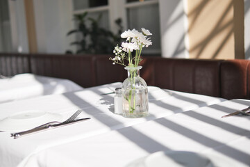 An Elegant Dining Table Displayed with a Beautiful Floral Centerpiece and Soft Ambient Lighting