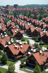 Aerial view of a suburban neighborhood with houses and satellite dishes.