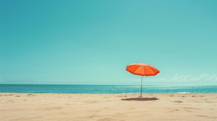 Bright Orange Umbrella on Sandy Beach Under Clear Sky