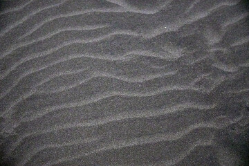 Pattern and texture background of black sand beach