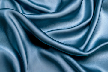 Fototapeta premium A close-up of smooth, blue silk fabric, showcasing its elegant texture and sheen.