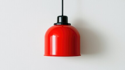 Fototapeta premium Vibrant red pendant lamp hanging against a clean white wall, showcasing modern design and bright color for stylish interiors.