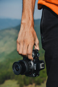 Himachal Pradesh, India- June 13, 2024: Canon eos R50 camera and photographer ready to take shutter on the nature of graden,Professional travel photography.