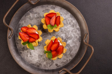 Strawberry Tart with Cream, Garnish with Mint Leaf. 