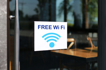 Free Wifi sign at the front entrance of the coffee shop to serve customers