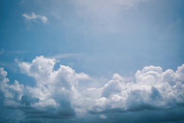 Tranquil Firmament: Puffed Clouds Gliding Across a Serene Blue Canvas.