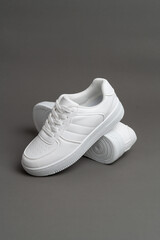 White sneakers isolated on grey background