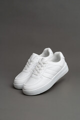 White sneakers isolated on grey background