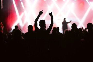 Crowd at concert and blurred stage lights.
