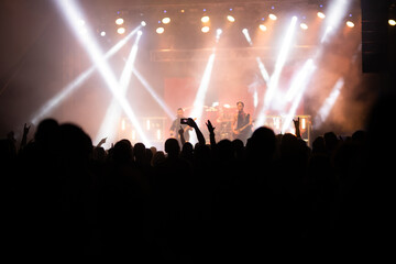 Crowd at concert and blurred stage lights.