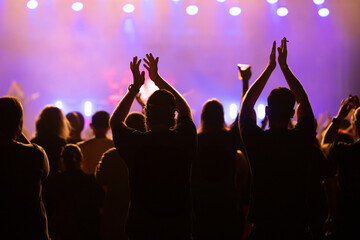 Crowd at concert and blurred stage lights.