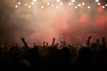 Crowd at concert and colorful stage lights.