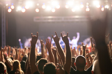 Crowd at concert and colorful stage lights.