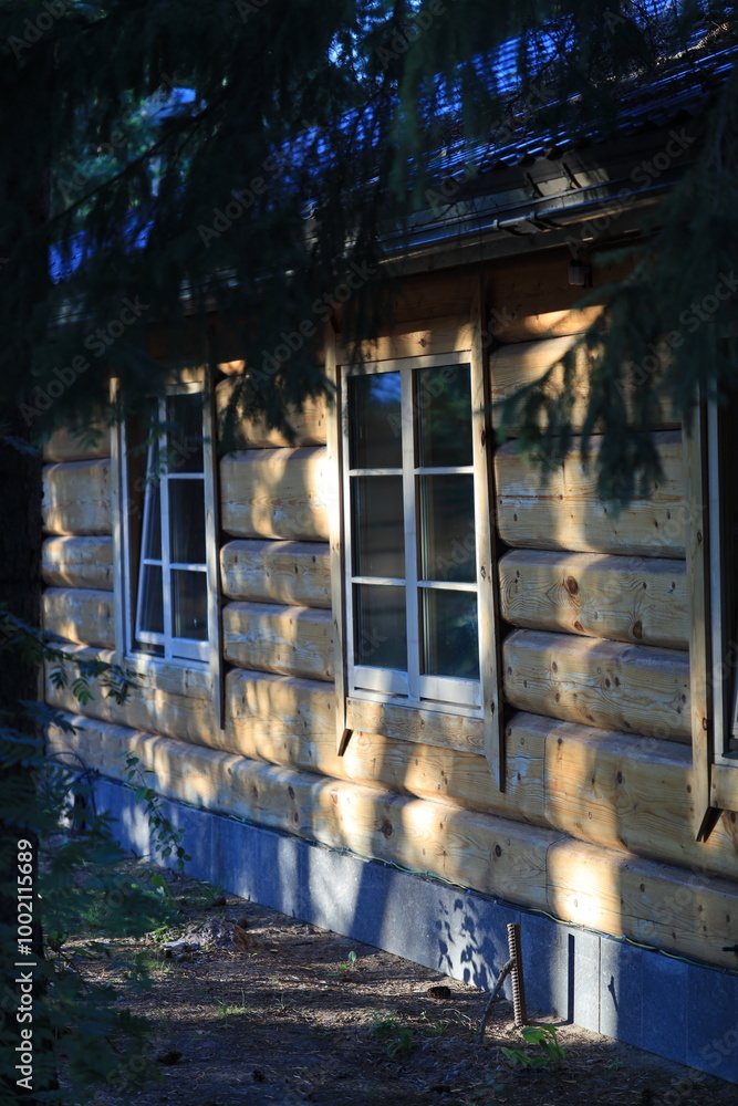 Aufkleber A tall wooden building with multiple windows, suitable for use in architectural or rustic-themed contexts.