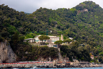 House on the hill near Portofino from the sea with dramatic sky