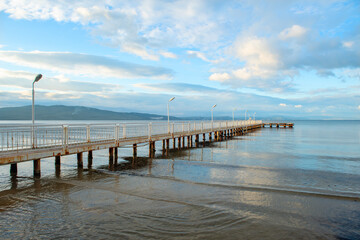 Wooden walking track built on the sea. Wooden bridge by the sea. Walking track with wooden floor and iron railings built in the sea. Quay walking area. Sea of ​​Erdek.