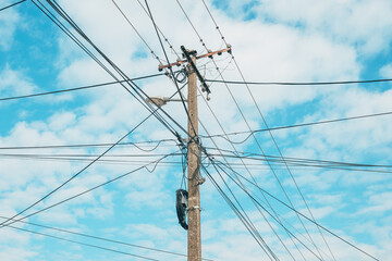 Concrete electrical post with cables and wires spreading in all directions