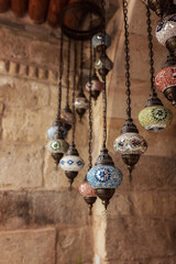 Beautiful lamps in Arabic style. Colorful hanging lanterns in traditional Arabic style handmade in the souvenir shop.