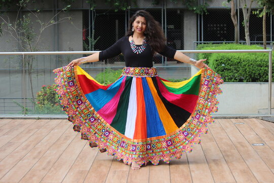 woman wearing full flair multi color chaniya for garba in Navratri. Stylish and modern indo western navratri look. Easy to carry traditional gujarati outfit, heavy neckless and oxidized jewellery. 