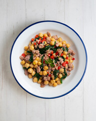 Catalan pork sausage with chickpeas and spinach. Top view table with  decorations.