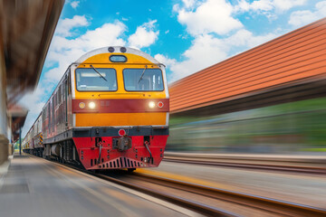 High speed locomotive diesel train passing near the passenger station in the city.