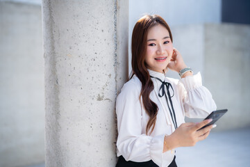 Portrait of beautiful happy Smiling asian woman relaxingread writing message on smartphone using casual working  in cafe interior in coffee shop background,Business Lifestyle summer holiday concept