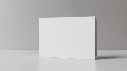 A white thick card with an elegant appearance on a gray background. The minimalist design gives an impression of luxury and simplicity