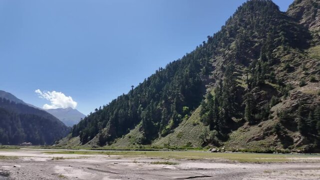 cynic Mountain Landscape with a Shimmering, Crystal-Clear River, Less Water Flow, Beautiful Sunshine, and Tree-Covered Mountains Under a Clear Sky 4K